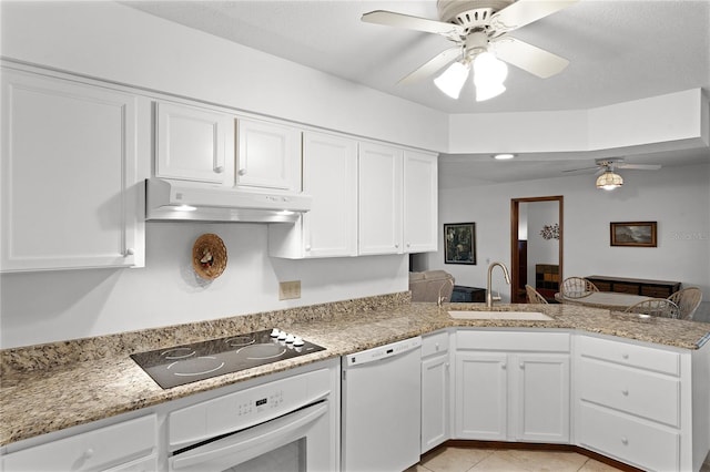 kitchen featuring white cabinets, white appliances, kitchen peninsula, and sink