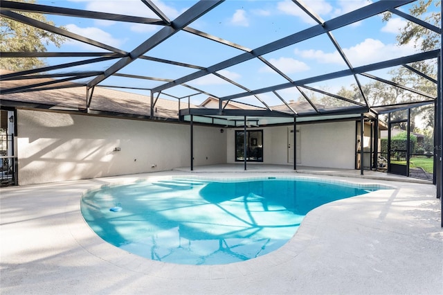 view of swimming pool featuring a lanai and a patio area