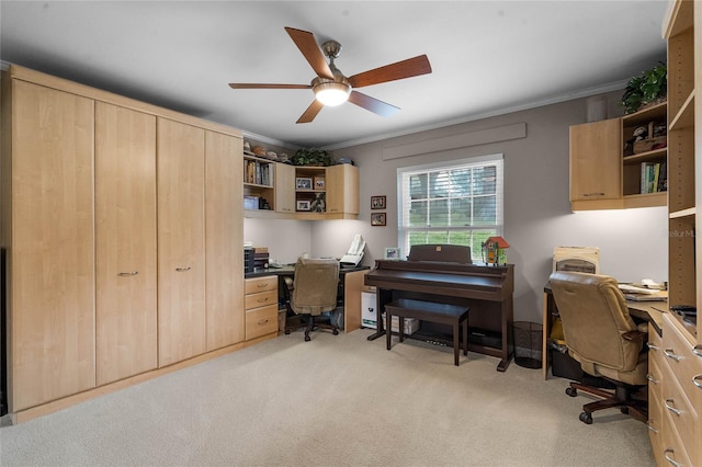 home office featuring crown molding, light colored carpet, and ceiling fan