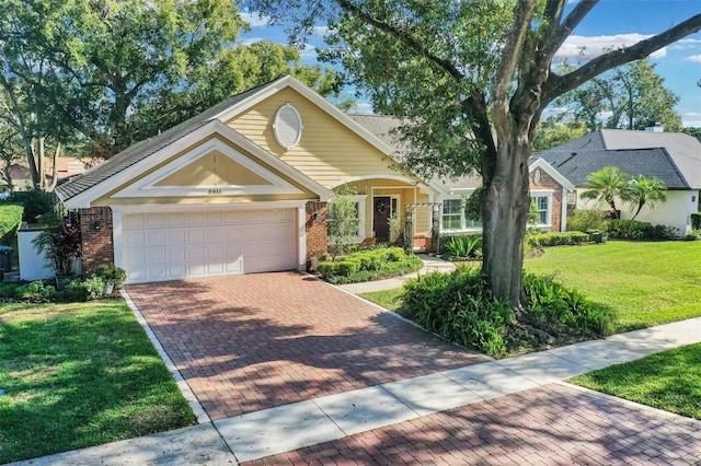 view of front of property with a front yard and a garage