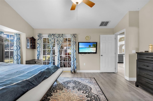 bedroom with ceiling fan, vaulted ceiling, and light hardwood / wood-style flooring