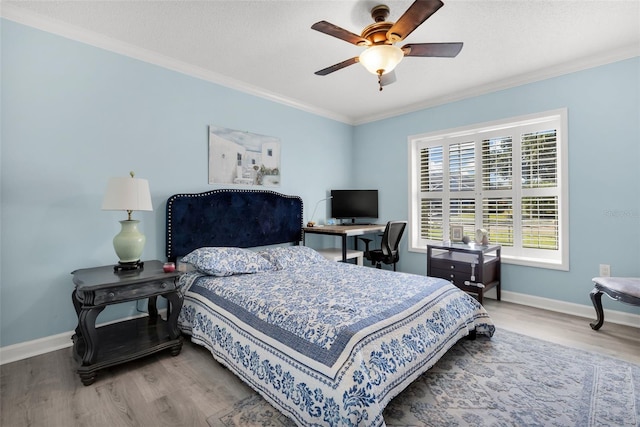 bedroom with ceiling fan, wood-type flooring, and crown molding