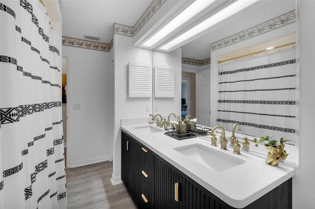 bathroom featuring a shower with curtain, vanity, and hardwood / wood-style flooring