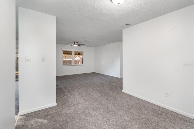 carpeted empty room with ceiling fan and a textured ceiling