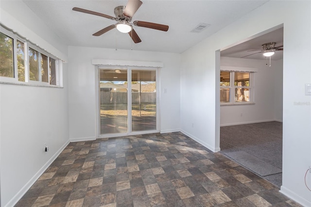 unfurnished room with a textured ceiling and ceiling fan