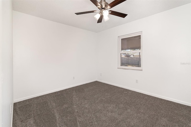 unfurnished room with dark colored carpet and ceiling fan