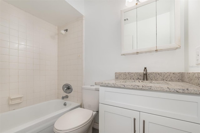 full bathroom featuring toilet, vanity, and tiled shower / bath