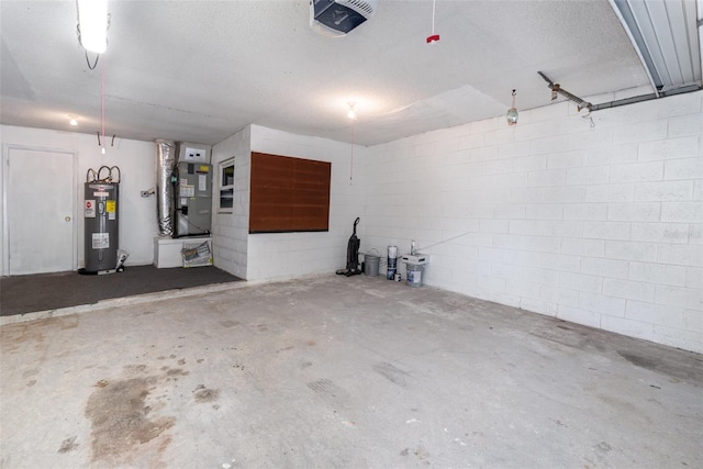 garage featuring heating unit, a garage door opener, and water heater