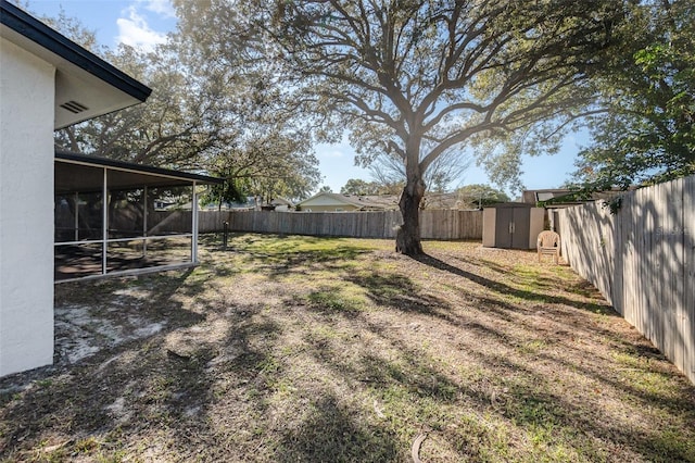 view of yard with a sunroom and a shed