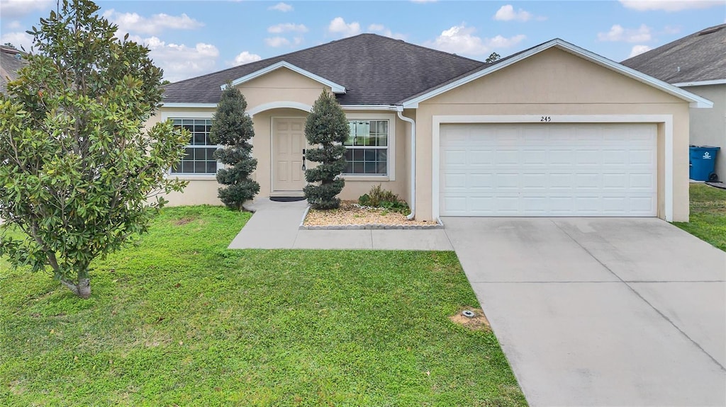 single story home with a garage and a front yard