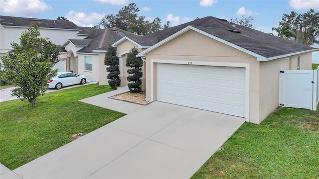 ranch-style home featuring a garage and a front yard