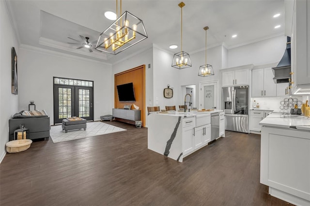 kitchen featuring hanging light fixtures, appliances with stainless steel finishes, dark wood-type flooring, and white cabinets