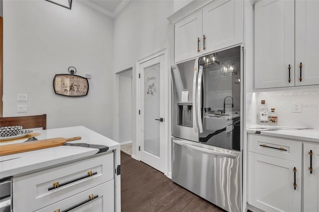 kitchen with white cabinets, dark hardwood / wood-style flooring, crown molding, stainless steel refrigerator with ice dispenser, and light stone countertops