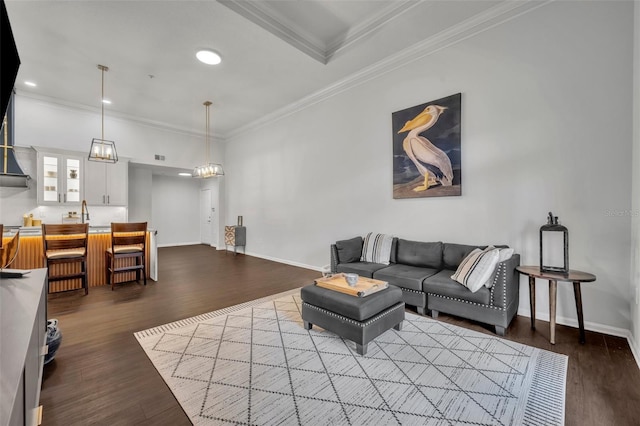 living room featuring wood-type flooring and crown molding