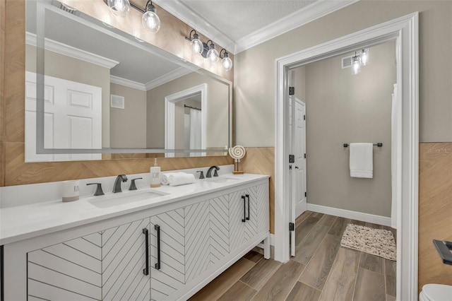 bathroom featuring crown molding, vanity, and a textured ceiling