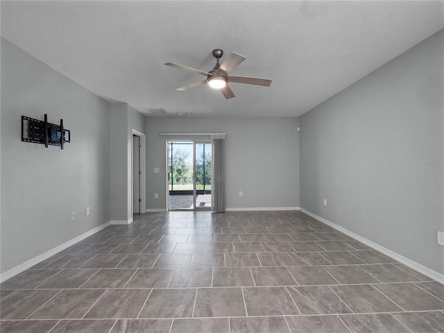 spare room with ceiling fan and a textured ceiling