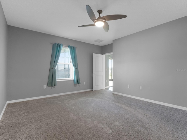 empty room featuring carpet flooring and ceiling fan