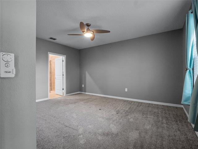 carpeted empty room featuring ceiling fan