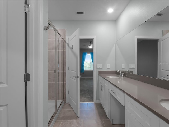 bathroom with tile patterned floors, vanity, ceiling fan, and an enclosed shower