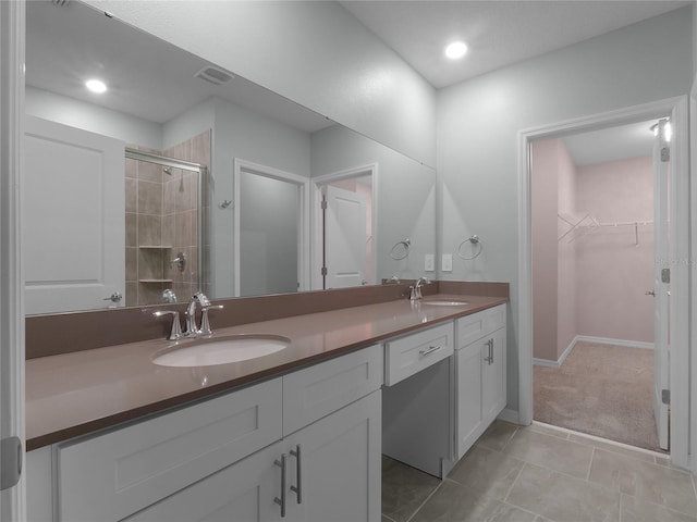 bathroom featuring tile patterned floors, vanity, and walk in shower