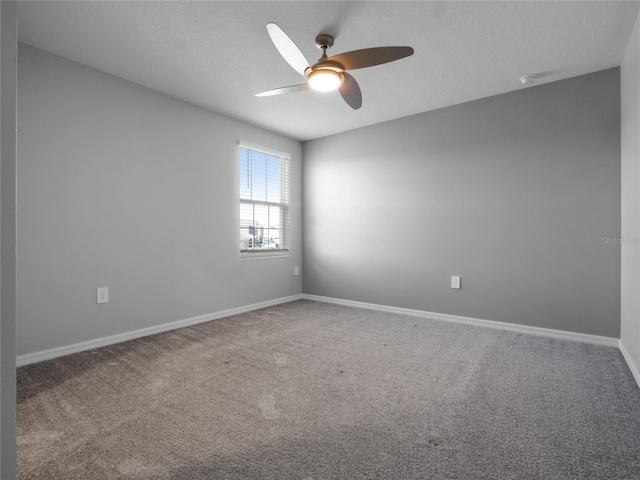 unfurnished room featuring ceiling fan and carpet floors