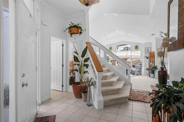 stairs featuring tile patterned flooring, lofted ceiling, and ornamental molding