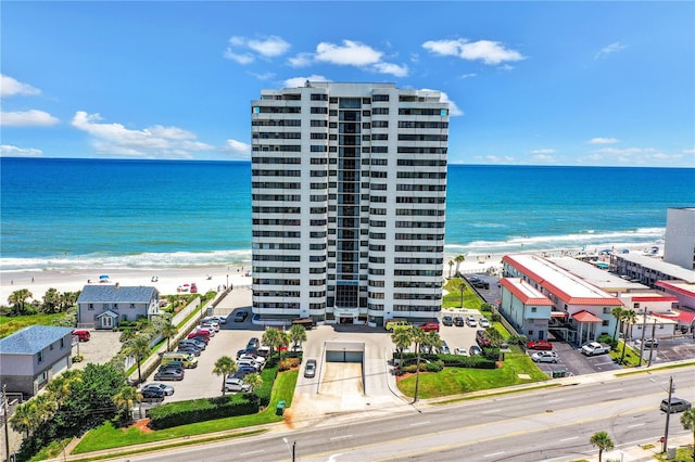 drone / aerial view featuring a water view and a view of the beach