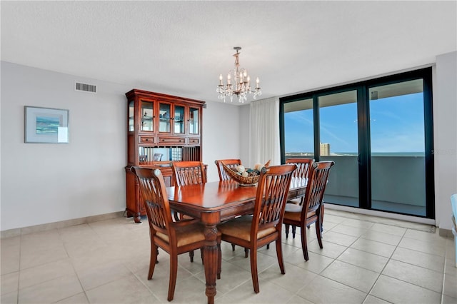 tiled dining space with a textured ceiling, floor to ceiling windows, and a notable chandelier