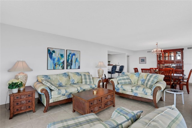 tiled living room featuring a textured ceiling and an inviting chandelier