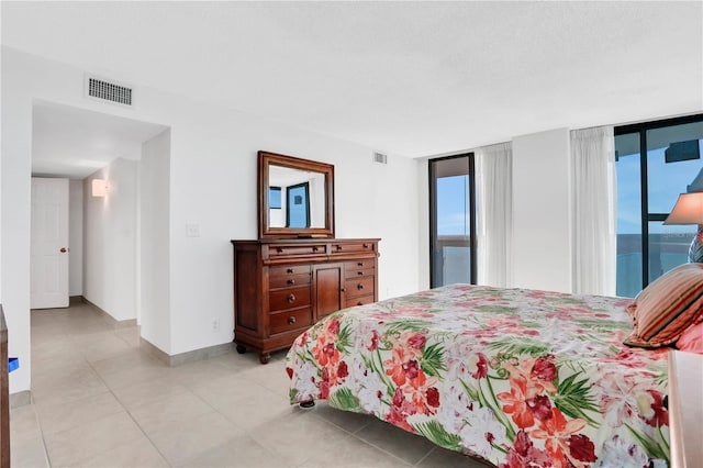 bedroom with access to outside and floor to ceiling windows