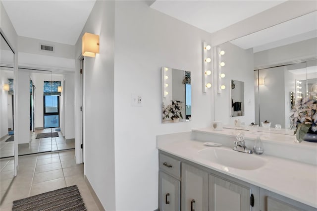 bathroom featuring tile patterned flooring and vanity