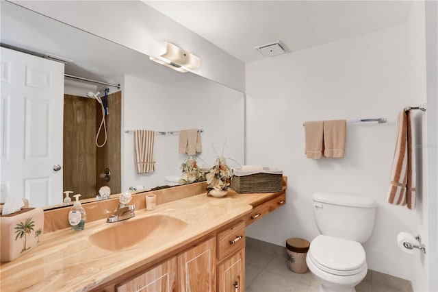 bathroom with a shower, vanity, toilet, and tile patterned flooring