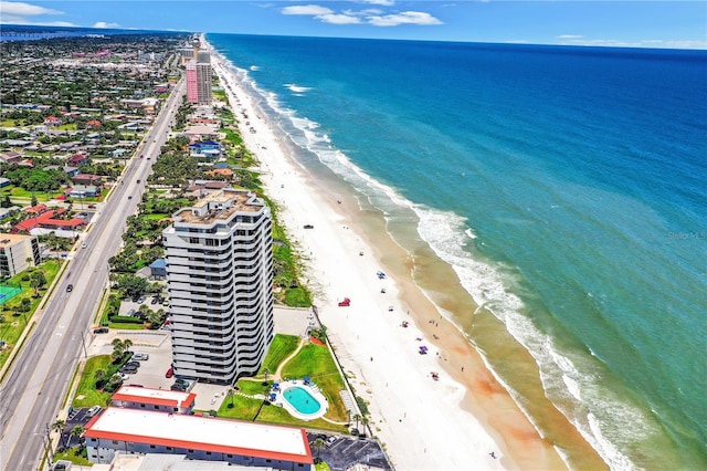 drone / aerial view featuring a view of the beach and a water view