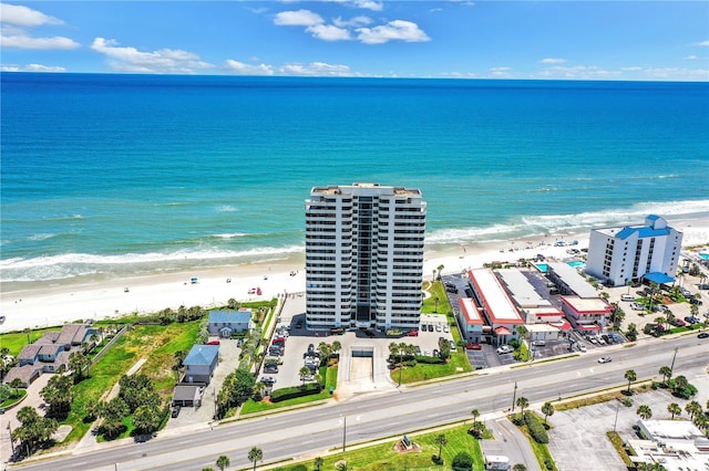 birds eye view of property with a beach view and a water view