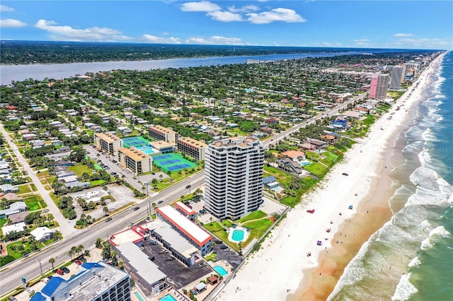 drone / aerial view with a water view and a beach view