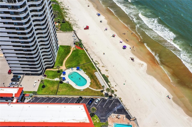 bird's eye view with a water view and a beach view