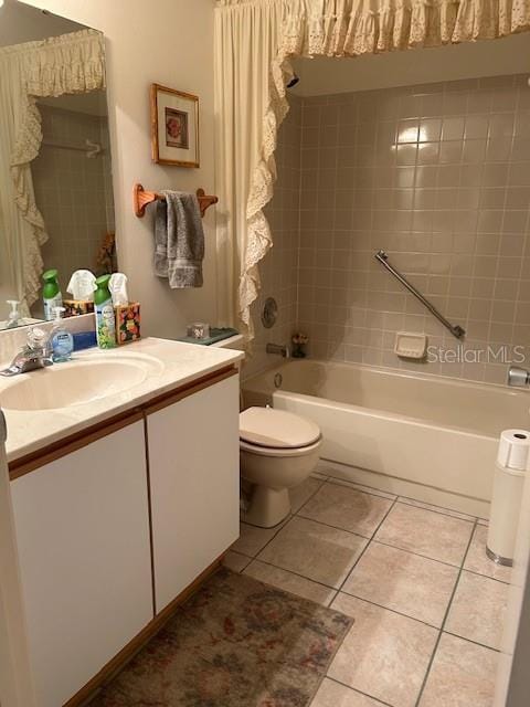 full bathroom with toilet, tiled shower / bath combo, tile patterned floors, and vanity