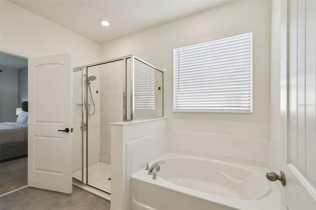 bathroom with tile patterned floors and independent shower and bath