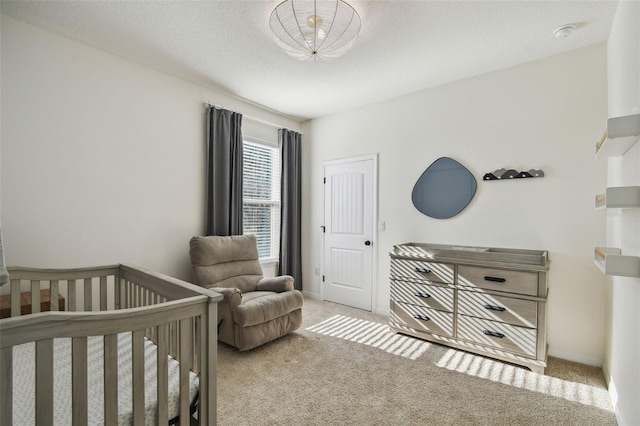 bedroom with a crib and light colored carpet