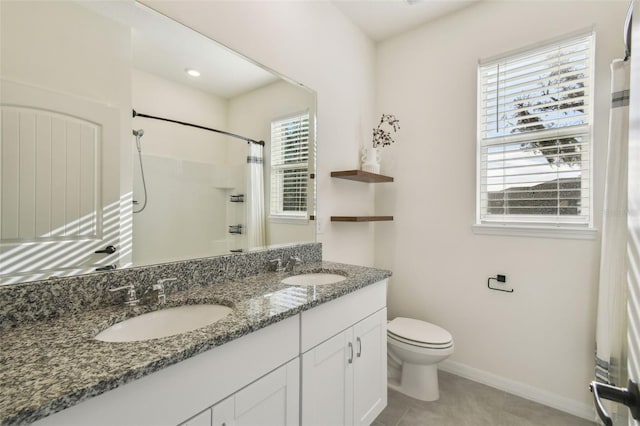 bathroom with a shower with shower curtain, vanity, toilet, and tile patterned floors