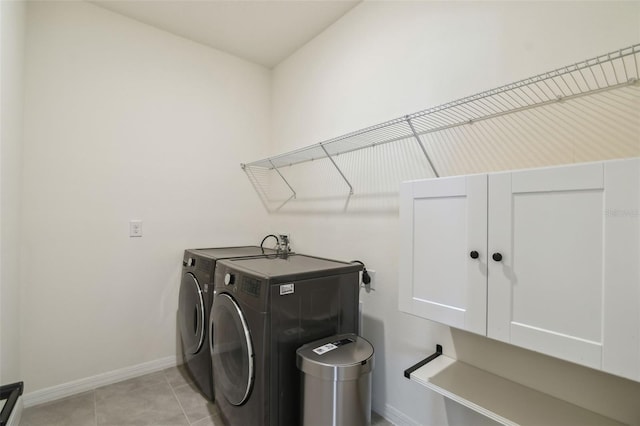 laundry area with light tile patterned flooring and washing machine and dryer