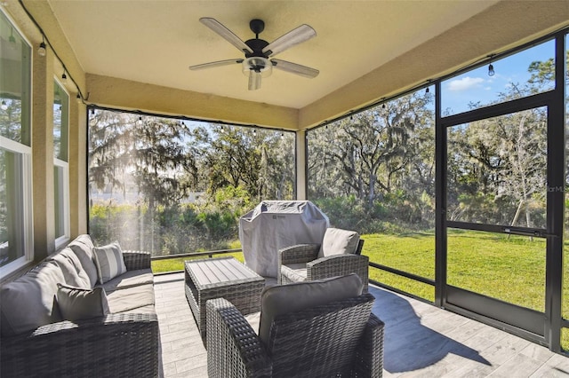 sunroom featuring ceiling fan