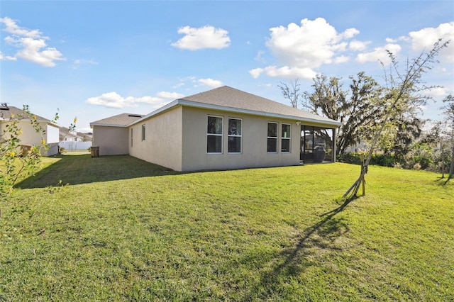 rear view of property featuring a yard