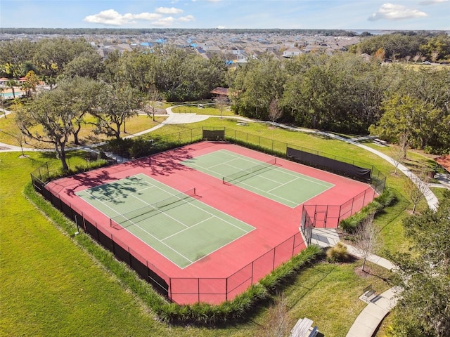 view of tennis court with a yard