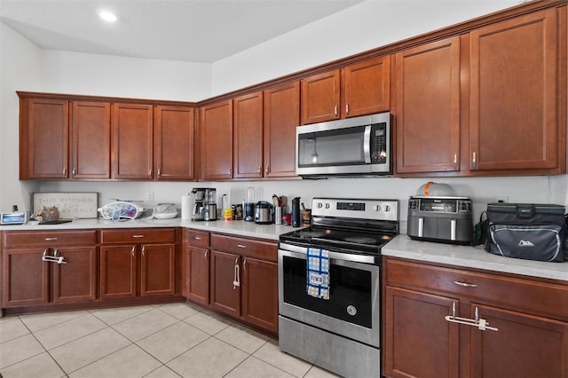 kitchen featuring light tile patterned floors and appliances with stainless steel finishes