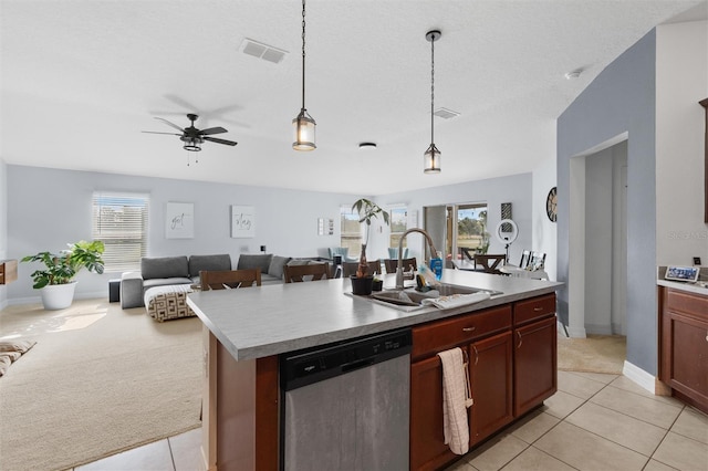 kitchen featuring stainless steel dishwasher, light colored carpet, a kitchen island with sink, sink, and decorative light fixtures