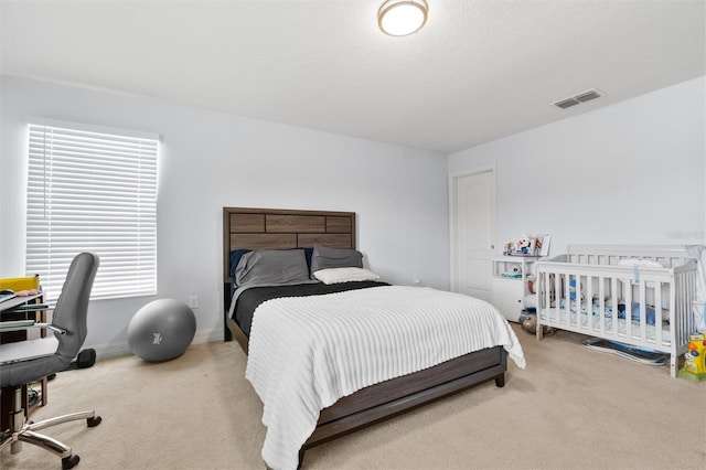 carpeted bedroom with multiple windows