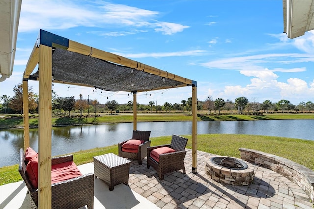 view of patio with a water view and an outdoor fire pit