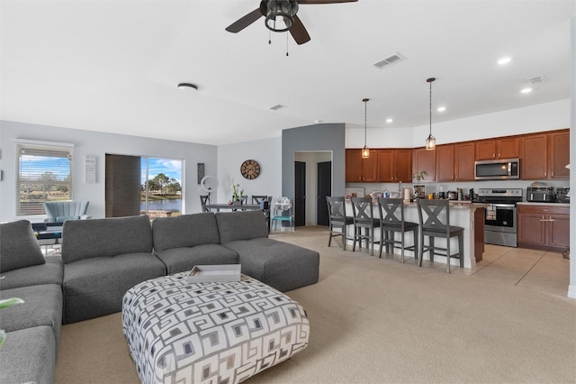 carpeted living room featuring ceiling fan