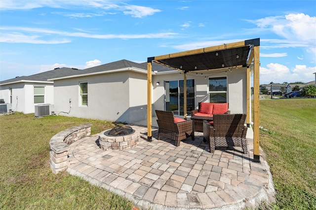 back of property with a yard, a patio, central AC, and an outdoor fire pit